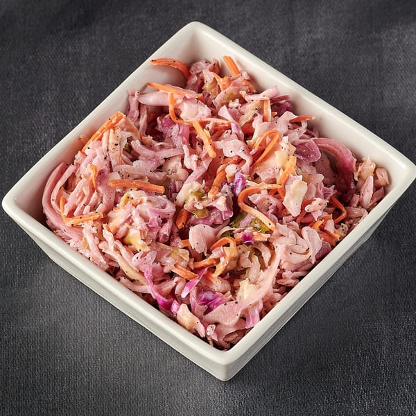 Hot Chicks House of Chicken's coleslaw, a side dish with shredded cabbage, carrots, and dressing.